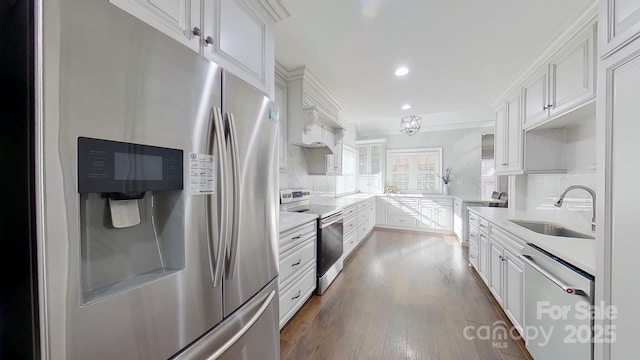 kitchen with white cabinets, stainless steel appliances, decorative backsplash, sink, and dark hardwood / wood-style floors