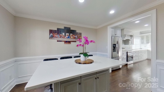 dining area with dark hardwood / wood-style floors and crown molding