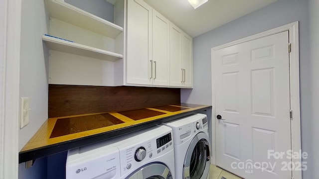 clothes washing area featuring washing machine and dryer and cabinets