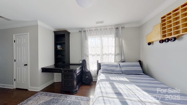 bedroom with dark wood-type flooring and crown molding