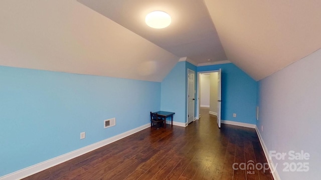 additional living space featuring lofted ceiling and dark hardwood / wood-style floors