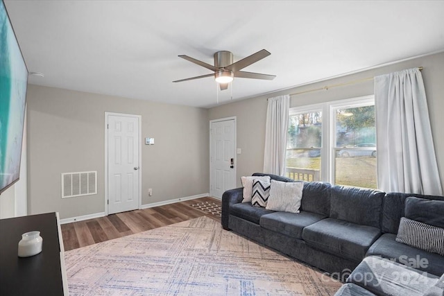 living room with hardwood / wood-style floors and ceiling fan