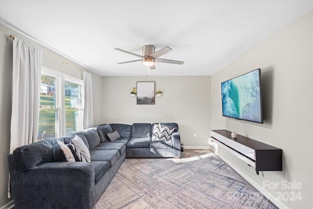 carpeted living room with ceiling fan