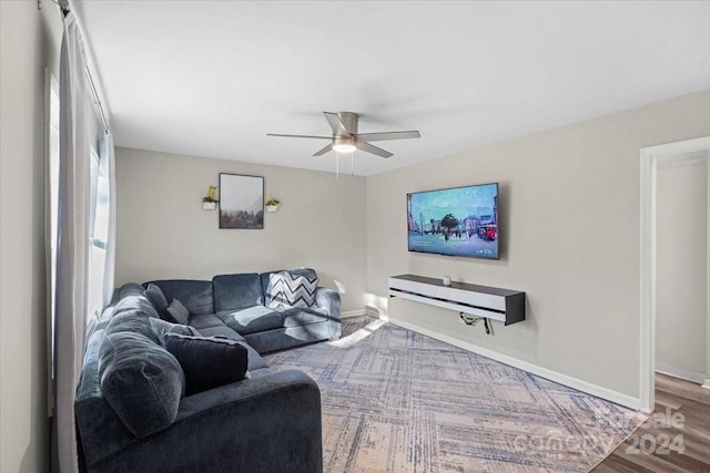 living room featuring ceiling fan and hardwood / wood-style flooring