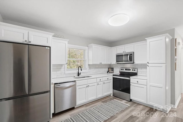 624 Dundeen Dr, Gastonia, NC 28052 - kitchen featuring stainless steel appliances, a sink, light countertops, and white cabinetry