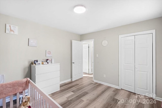 unfurnished bedroom with light hardwood / wood-style flooring and a closet