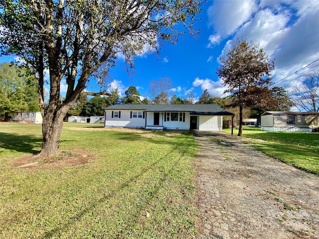 single story home with a front lawn and a carport