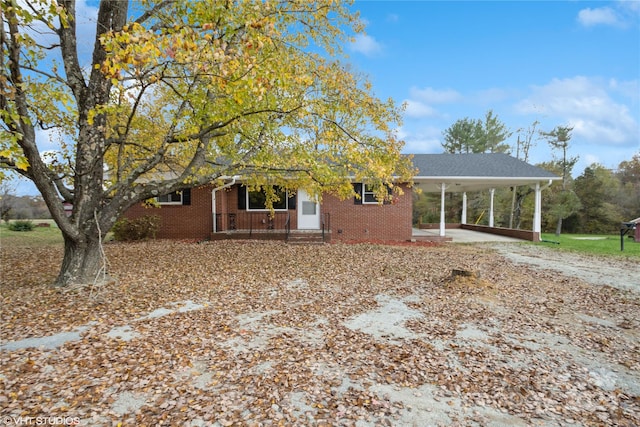 view of front of home featuring a carport and covered porch