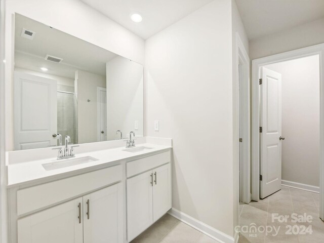 bathroom with vanity, tile patterned floors, and an enclosed shower