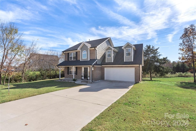 view of front of house with a front yard, a porch, and a garage