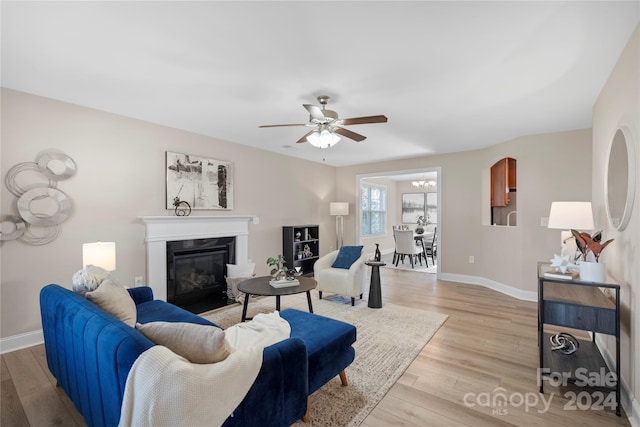 living room featuring ceiling fan and light wood-type flooring