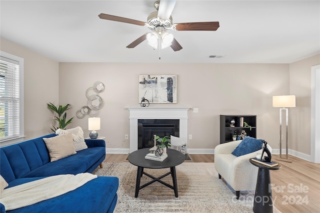 living room featuring ceiling fan and light hardwood / wood-style floors