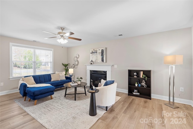 living room featuring ceiling fan and light hardwood / wood-style floors