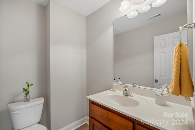 bathroom featuring vanity and toilet