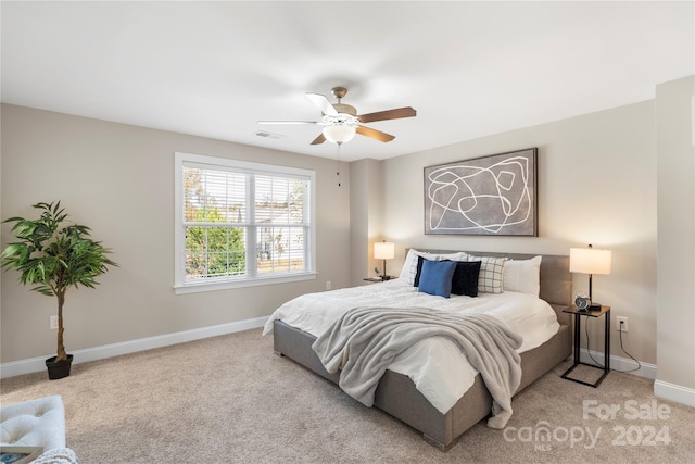 bedroom with light carpet and ceiling fan