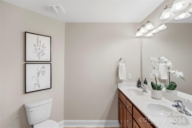 bathroom featuring vanity and toilet