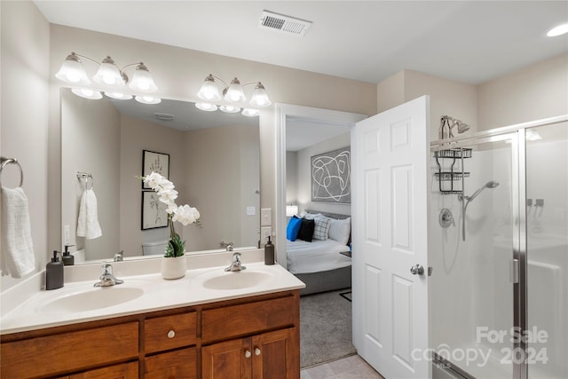 bathroom with tile patterned floors, vanity, a shower with shower door, and toilet