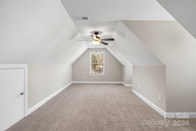 bonus room featuring ceiling fan, light colored carpet, and vaulted ceiling