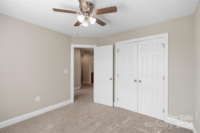 unfurnished bedroom featuring carpet flooring, ceiling fan, and a closet