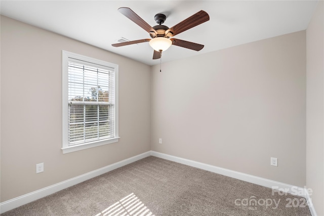 spare room featuring carpet flooring and ceiling fan