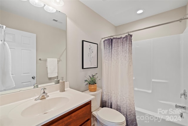 full bathroom with vanity, shower / bath combo, and toilet