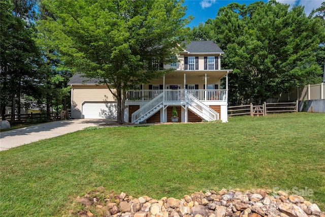 colonial inspired home featuring covered porch, a front yard, and a garage