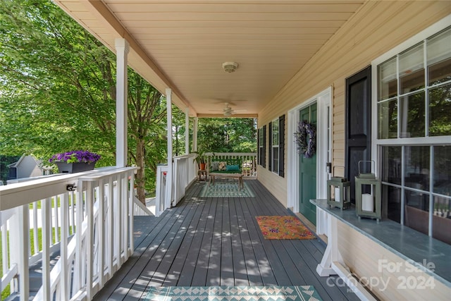 wooden deck with covered porch and ceiling fan