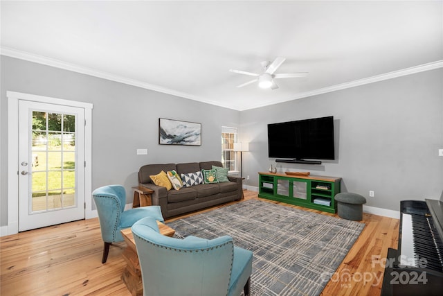 living room featuring ceiling fan, wood-type flooring, and ornamental molding