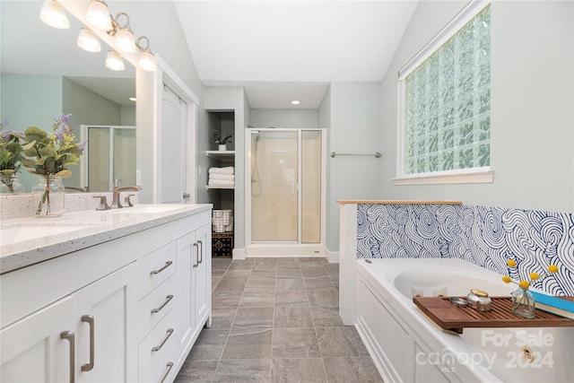 bathroom featuring tile patterned flooring, vanity, a shower with door, and lofted ceiling