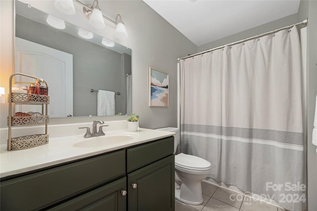 bathroom with vanity, vaulted ceiling, tile patterned flooring, toilet, and curtained shower