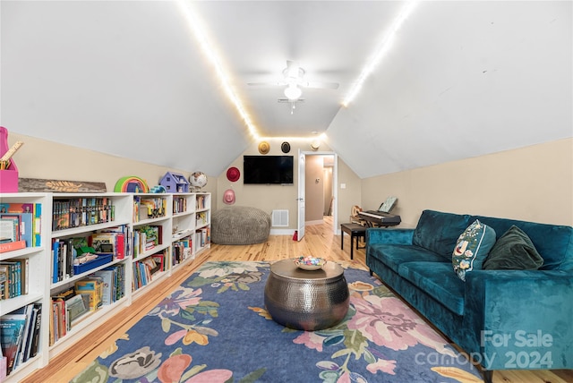 game room with ceiling fan, hardwood / wood-style flooring, and lofted ceiling