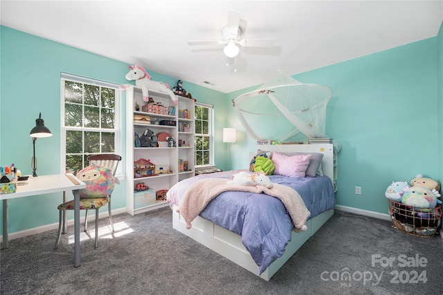 carpeted bedroom featuring multiple windows and ceiling fan