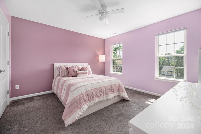 bedroom with dark colored carpet and ceiling fan