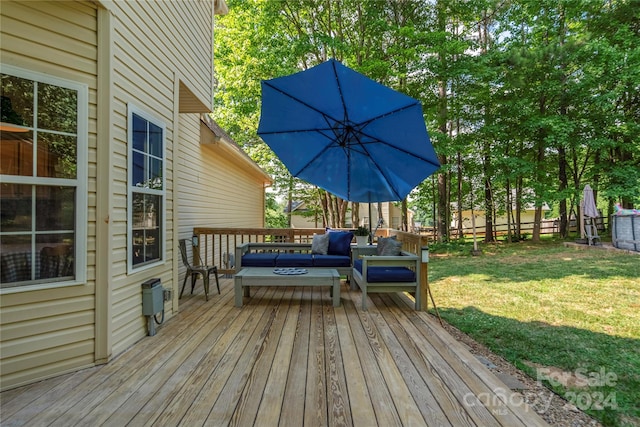 wooden terrace with a yard and an outdoor hangout area