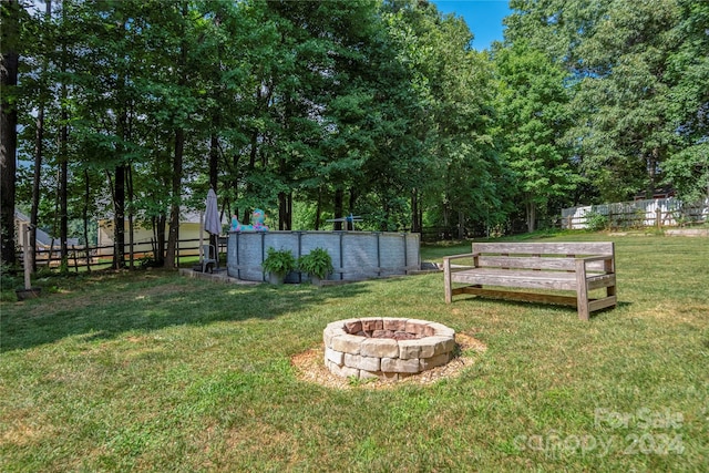 view of yard with a fire pit