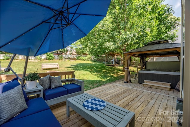 deck featuring a gazebo, an outdoor living space, and a yard