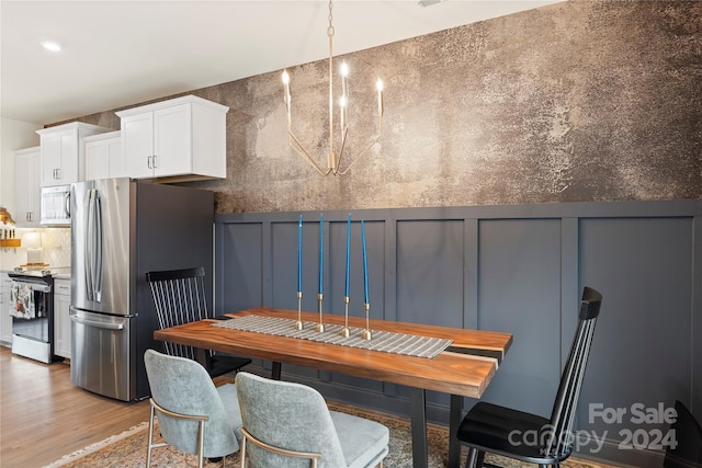 interior space with a chandelier and light hardwood / wood-style flooring