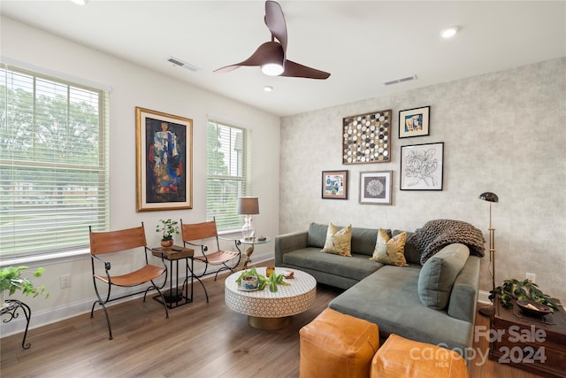 living room featuring a wealth of natural light, ceiling fan, and wood-type flooring