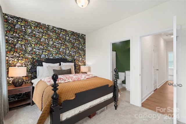 carpeted bedroom featuring connected bathroom