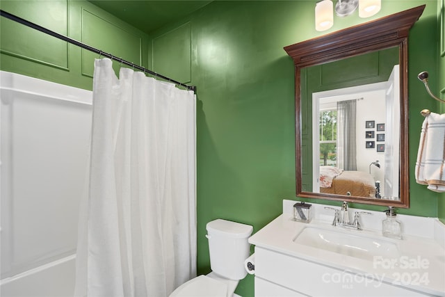 full bathroom featuring vanity, shower / bath combination with curtain, and toilet