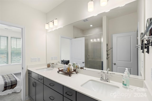 bathroom with vanity and an enclosed shower