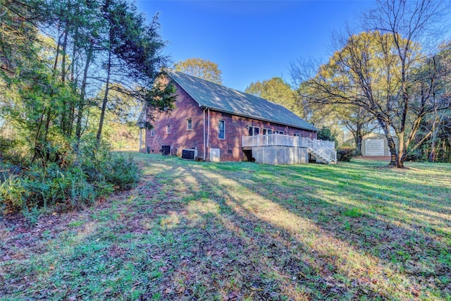 view of yard featuring central AC unit and a wooden deck