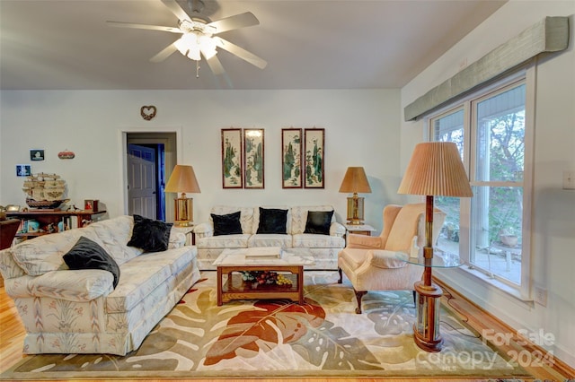 living room with ceiling fan and light hardwood / wood-style floors