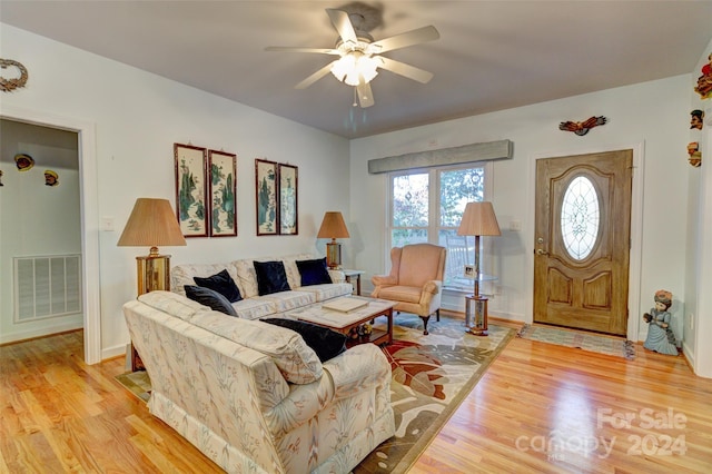 living room with ceiling fan and light hardwood / wood-style floors