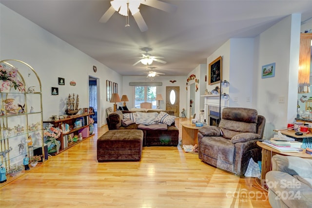 living room featuring light wood-type flooring and ceiling fan