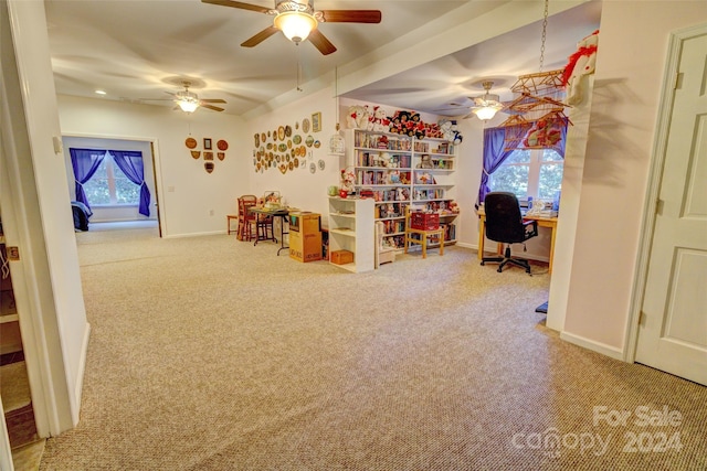 home office featuring ceiling fan, a healthy amount of sunlight, and carpet floors