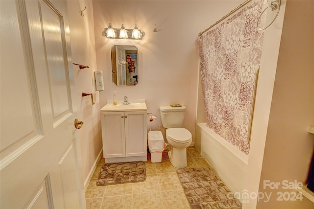 full bathroom with tile patterned flooring, shower / bath combo with shower curtain, vanity, and toilet