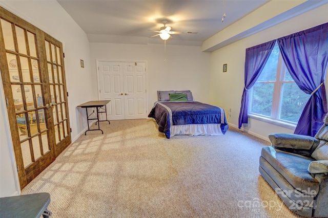 bedroom with light carpet, a closet, and ceiling fan