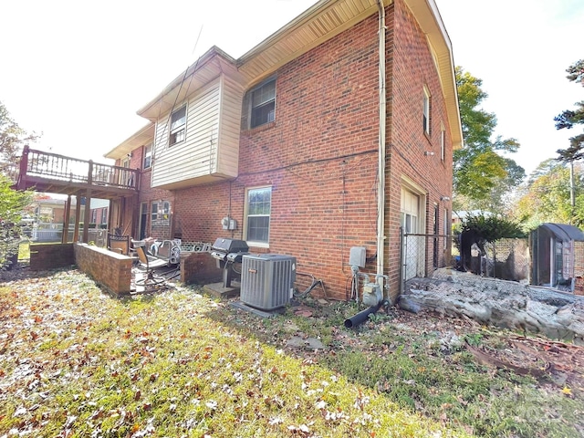 back of house with central AC unit