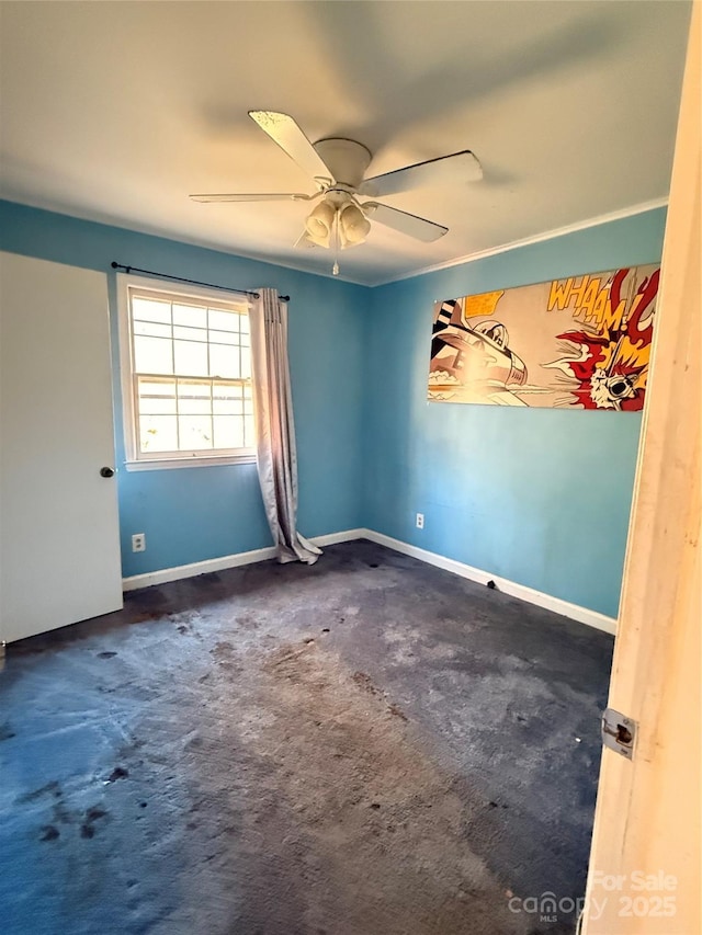 unfurnished room with ceiling fan and dark carpet